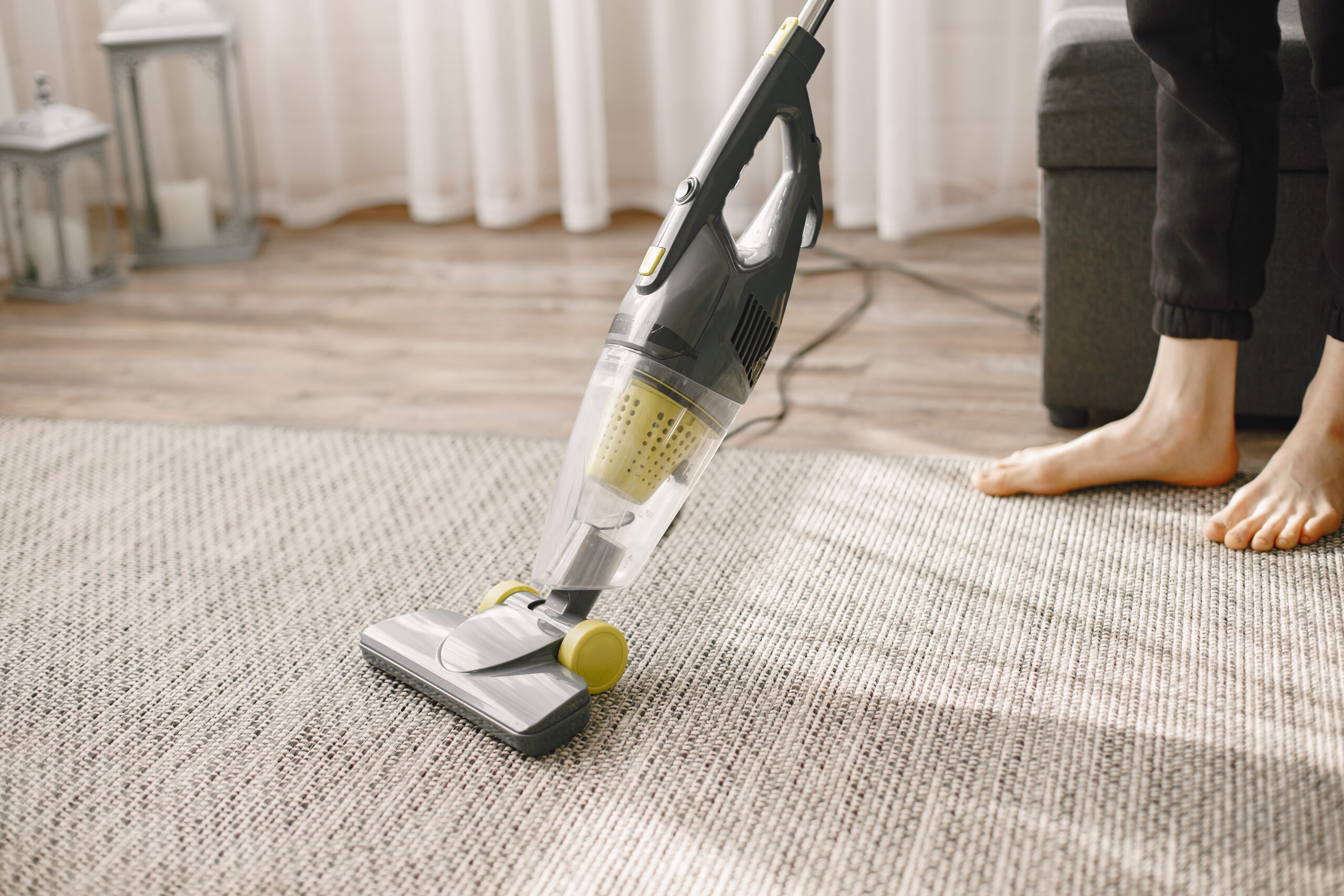 Girl dancing with a vacuum cleaner. Woman in a striped top. Lady cleans the house